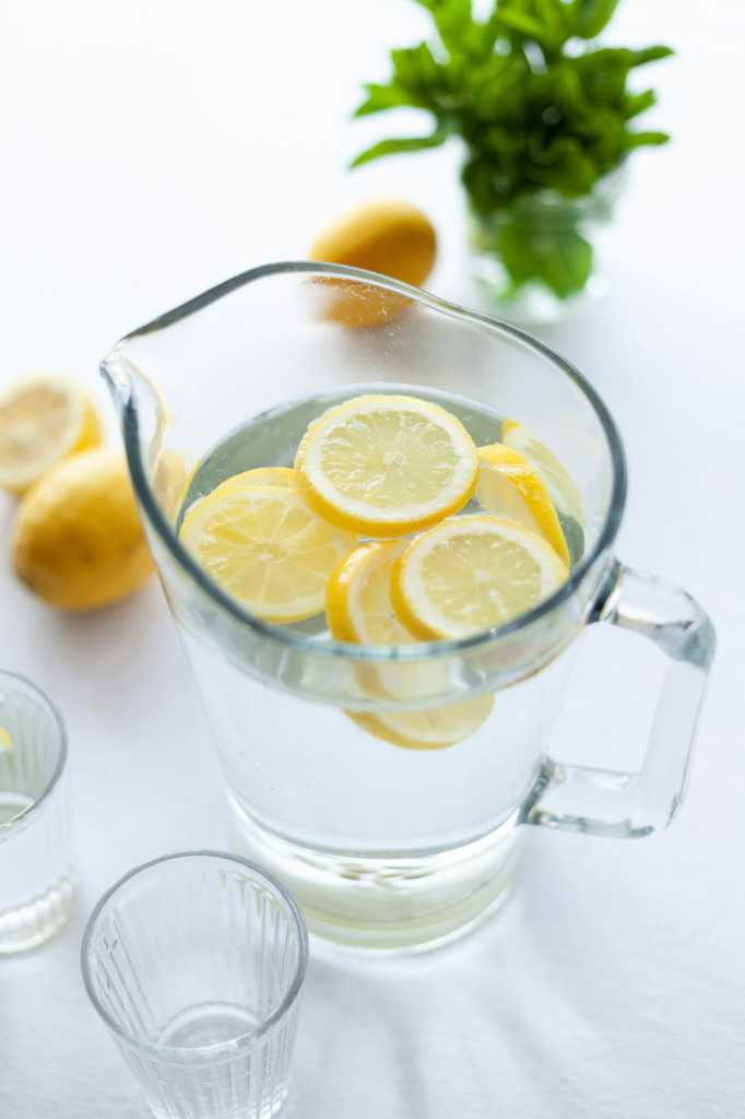 A pitcher of water with fresh lemon slices.