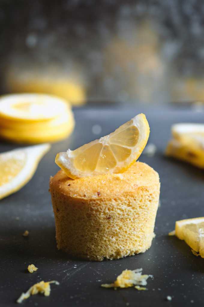 A lemon cupcake with a lemon slice on top.